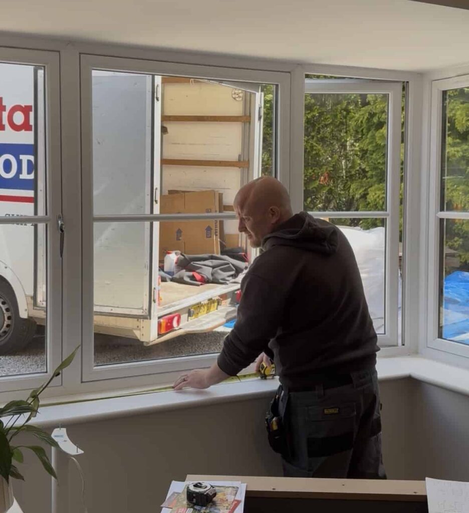 this image shows one of our installers surveying a bay window the day a client has moved in