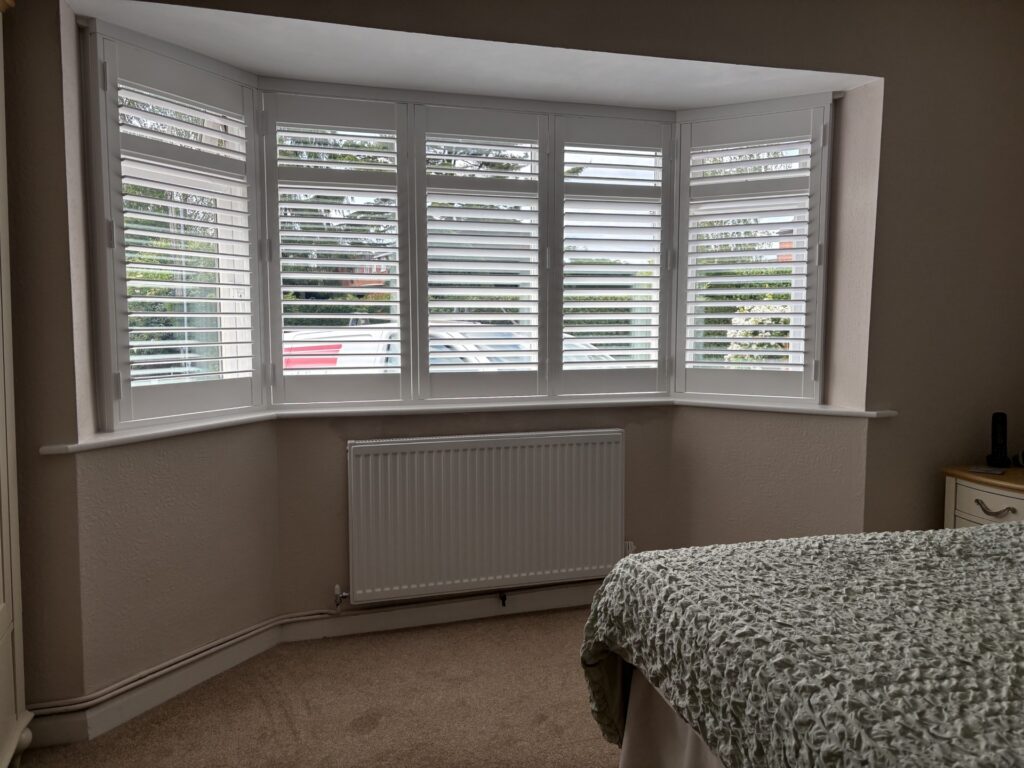 this image shows the after install of shutters in a bay window